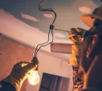 Tolmie Electric technician installing a pendant light fixture